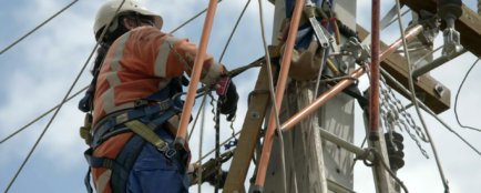 Team member working on the overhead power line